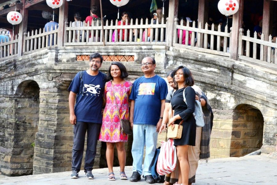 Indian family posing on Hoi An's Japanese Bridge