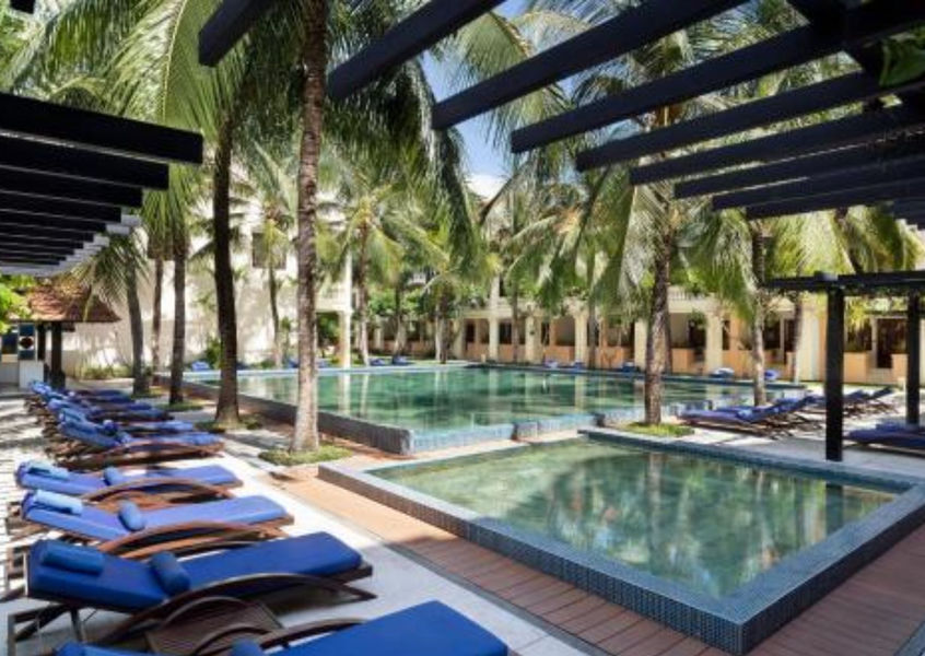 Anantara Hoi An Resort outdoor pool with palm trees and sun loungers