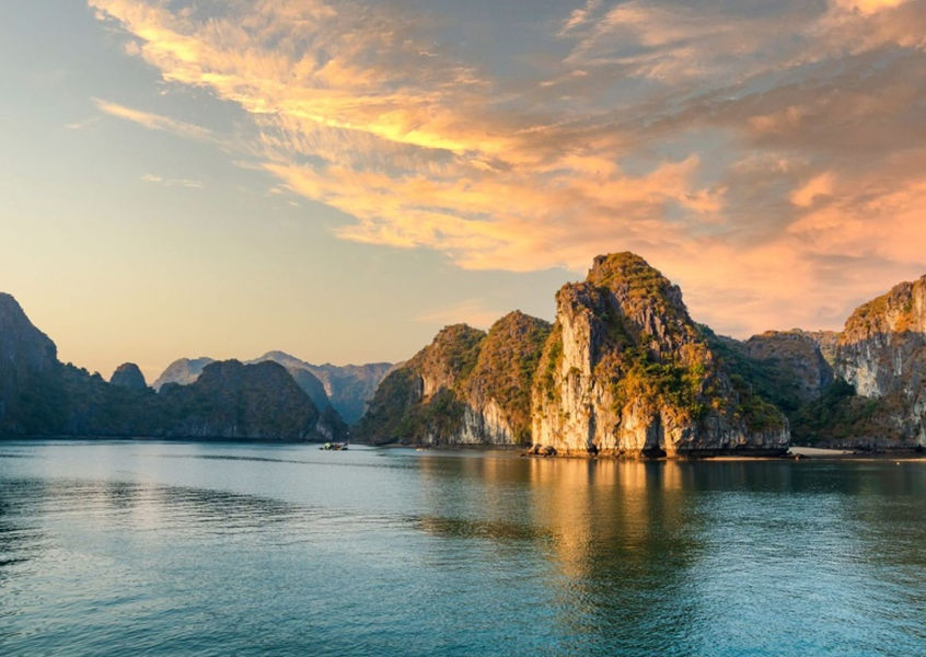Limestone karst islands at sunset in Halong Bay