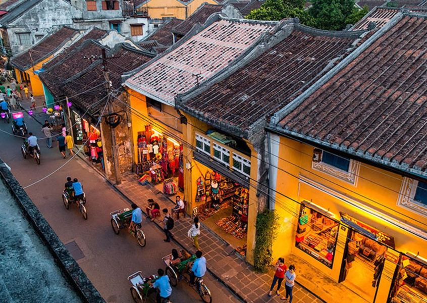 Yellow heritage buildings along a street in Hoi An Ancient Town