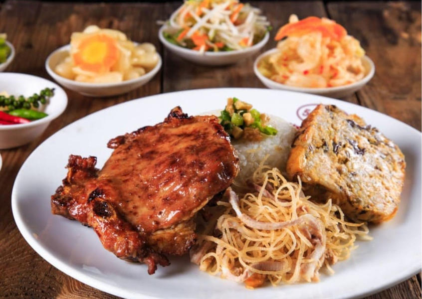 A plate of Vietnamese broken rice with grilled pork chop