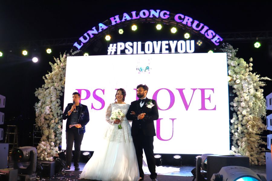 Bride and groom on stage aboard Halong Bay cruise wedding