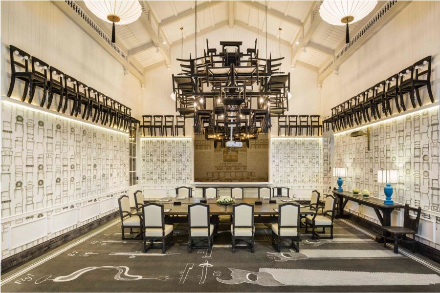 Meeting room with ornate ceiling art installation and patterned walls