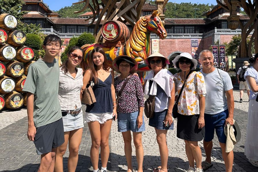 Indian family group posing at a heritage site during a Vietnam Diwali season tour