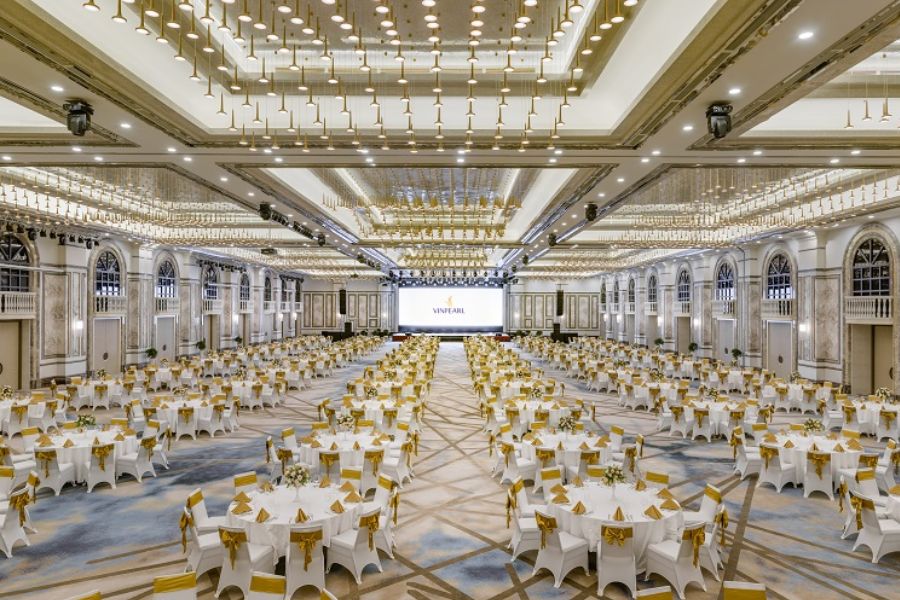 Grand Vinpearl ballroom set up for a gala with gold table accents