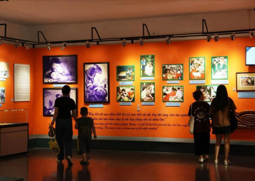 Family viewing Agent Orange exhibit photo displays