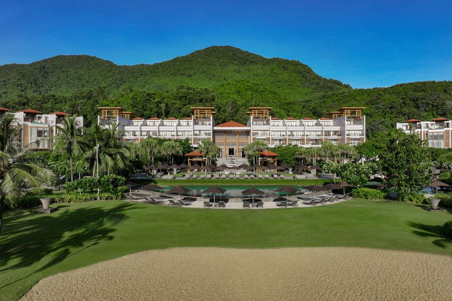 Angsana Lang Co resort complex with landscaped gardens, outdoor pool, and golf course bunker