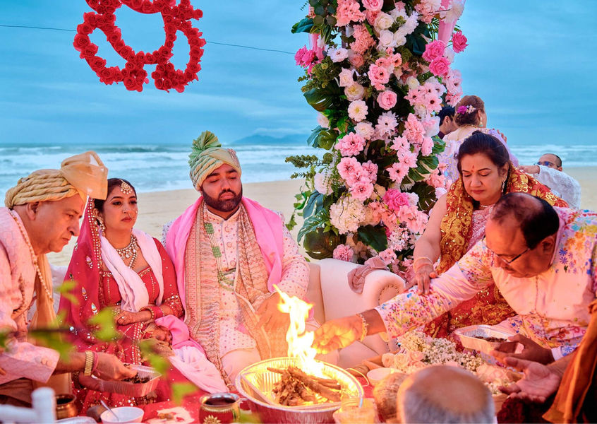 Indian couple performs beach fire ceremony at sunset in Vietnam
