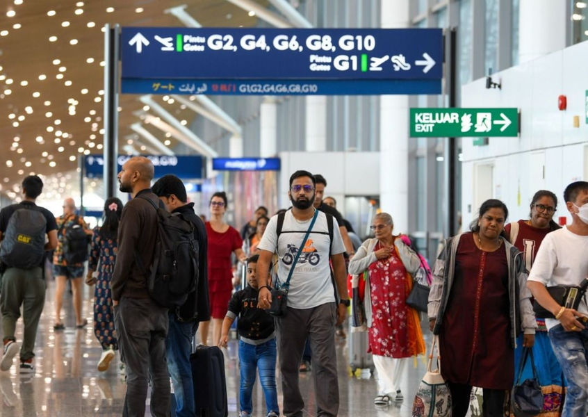 Travelers walking through an international airport terminal