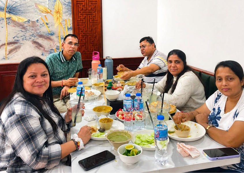 Travelers seated at Rutba Indian Restaurant Hanoi thali table