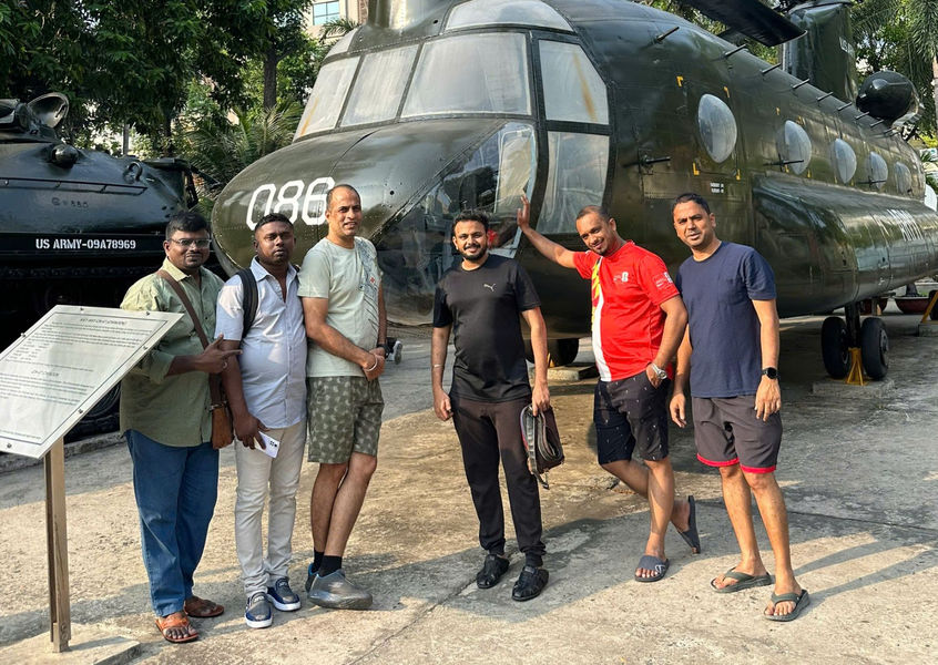 Tour group photo with helicopter in courtyard