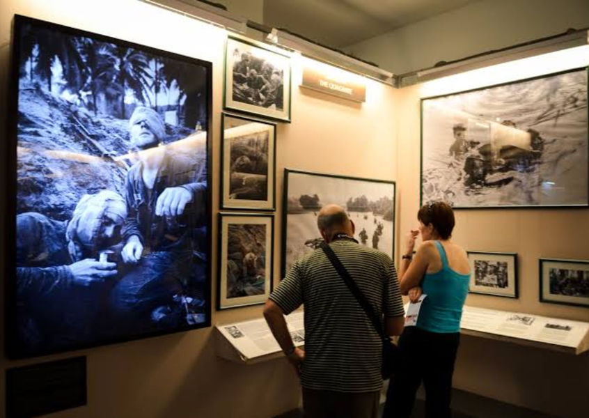 Visitors viewing black and white war photography