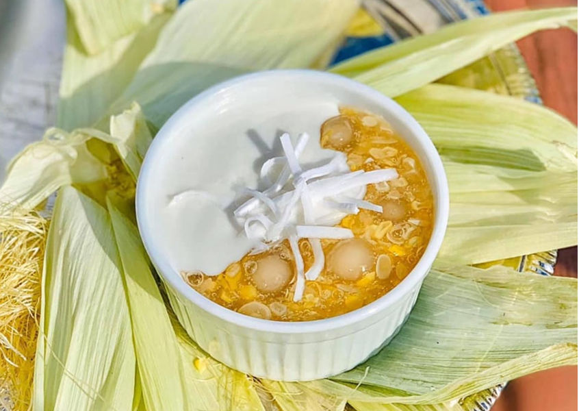Che Bap sweet corn dessert served in corn husk wrapping