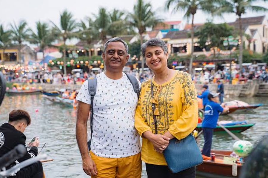 Couple at Hoi An Ancient Town riverside at sunset, Vietnam