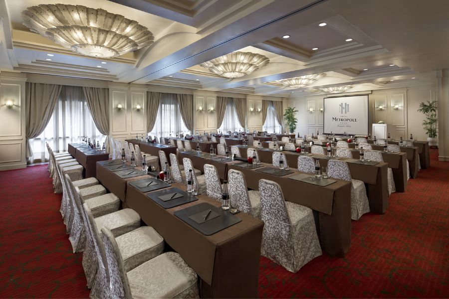 Classroom-style meeting room setup with ornate ceiling details at a heritage hotel in Hanoi