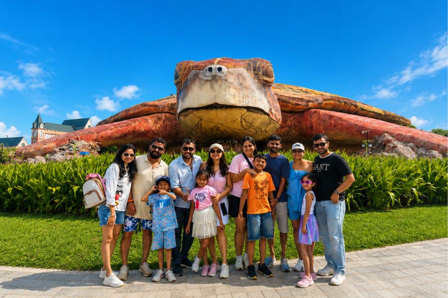 Family group photo at Vietnam theme park turtle statue