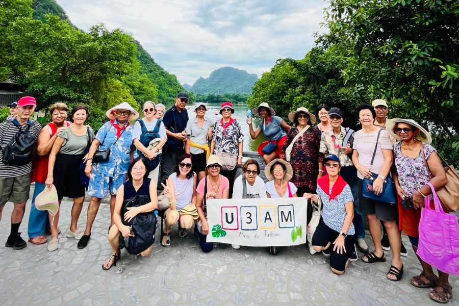Tour group photo at Trang An, Ninh Binh landscape